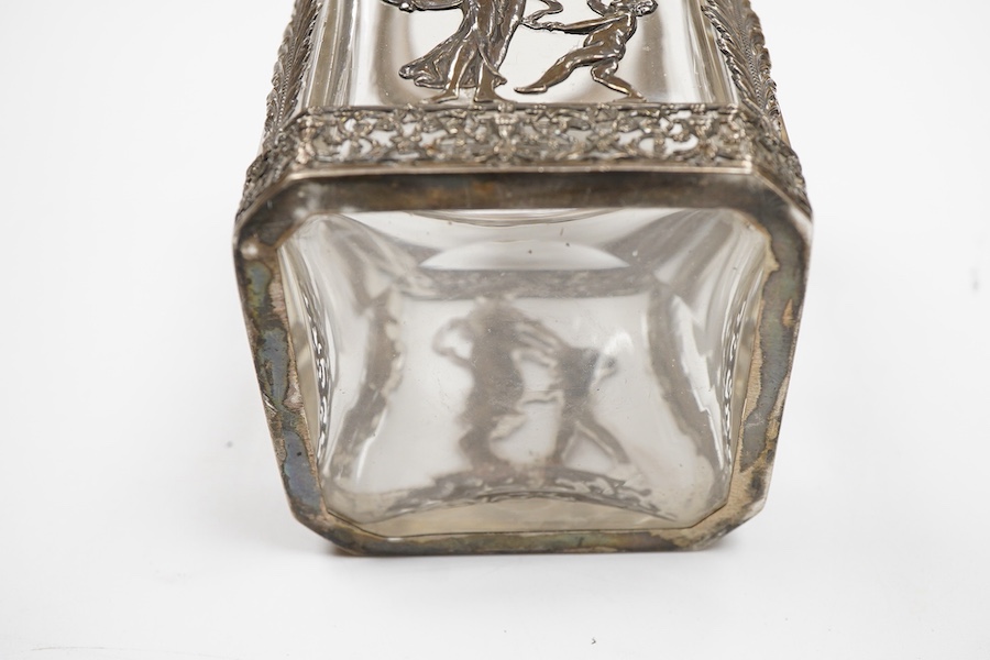 A late 19th/early 20th century French 800 standard pierced white metal mounted glass jar or tea caddy and stopper, decorated with classical scene of a lady with child, height 13.2cm.